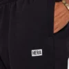 Pantaloni sportivi da uomo The Collective – neri Pantaloni sportivi da uomo The Collective – neri